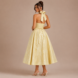 Ángela - Rochie midi halter cu fundă și fustă voluminoasă.